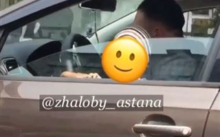 «Говорит по телефону, на руках ребенок»: водитель возмутил казахстанцев